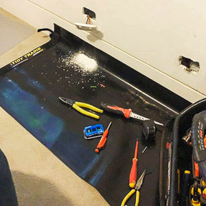Electrician protecting the customers carpet while working over a large tidy tradie work mat
