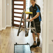 Load image into Gallery viewer, Electrician wearing cleanboot covers and using a medium tidy tradie work mat to protect the floor.
