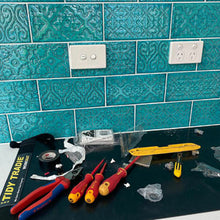 Load image into Gallery viewer, An electrician working over a tidy tradie work mat to protect the kitchen bench top.
