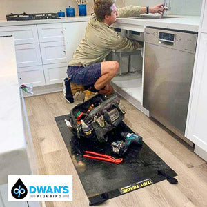 A professional with his tools on a medium tidy tradie work mat, to protect the timber floor.