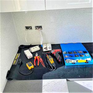 Electrician work mat for protecting the kitchen bench top from tool damage.