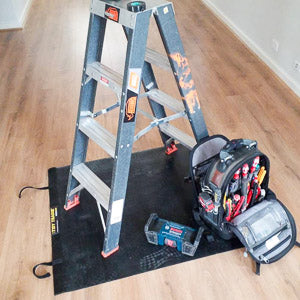 Large size Tidy Tradie Work Mat, used by electricians. Showing ladder and tools on rubber mat