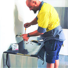 Load image into Gallery viewer, Electrician using a Tidy Tradie work mat to protect the clients property.
