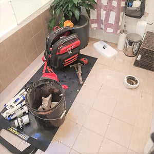 Medium size Tidy Tradie work mat, used by a plumber to protect the floor tiles.